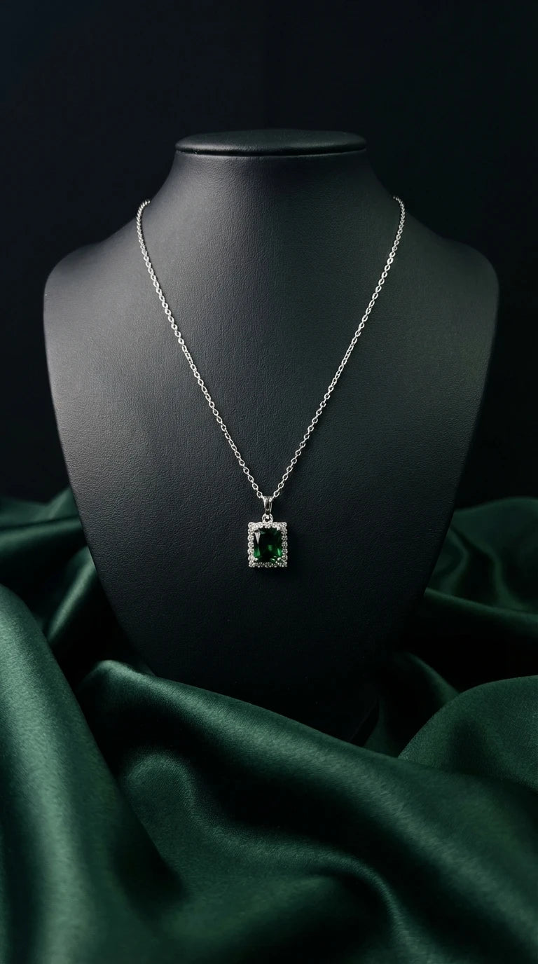 Necklace with a pendant on a black mannequin against a dark green fabric background