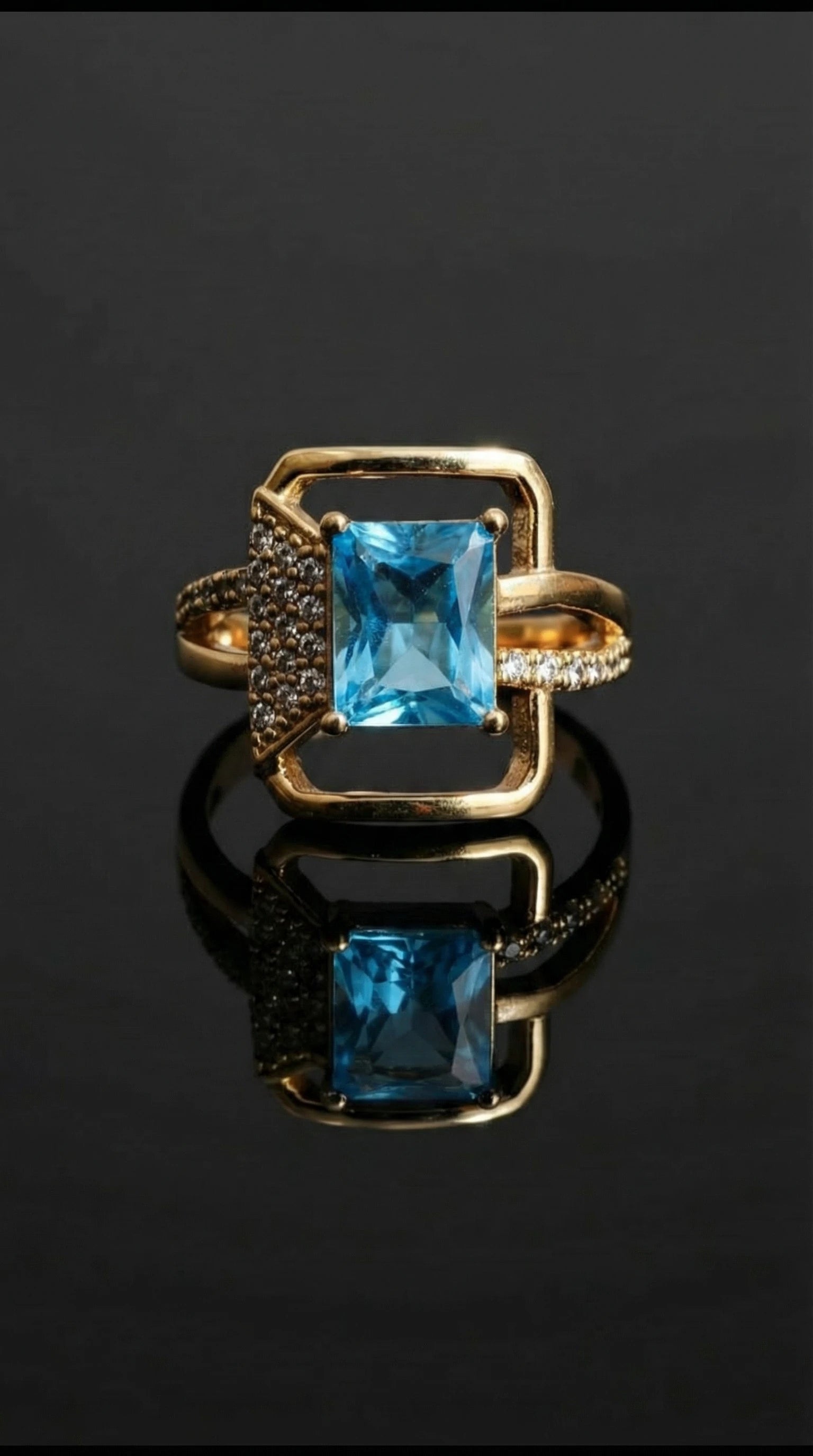 Gold ring featuring a square-cut blue gemstone centerpiece with pavé diamond accents on one side of the band.