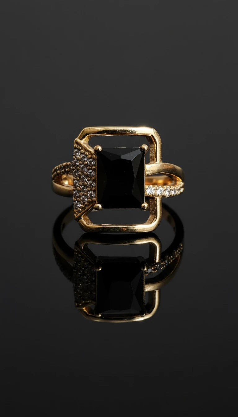 Gold ring featuring a square-cut black gemstone centerpiece with pavé diamond accents on one side of the band.