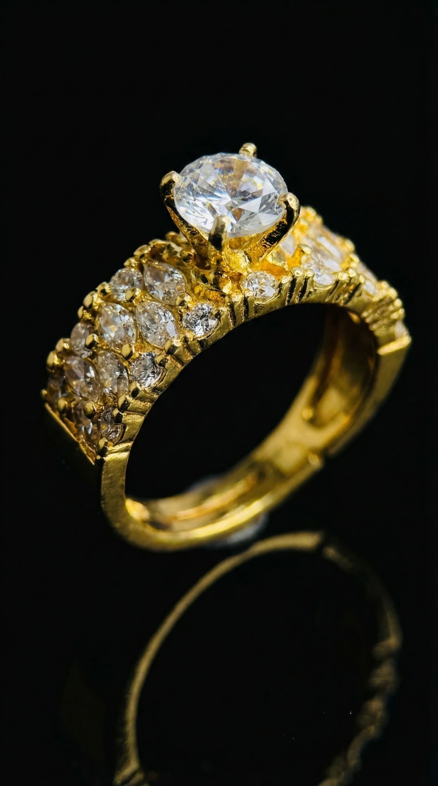 Gold ring with a large round-cut central diamond and multiple smaller diamonds set along the band.